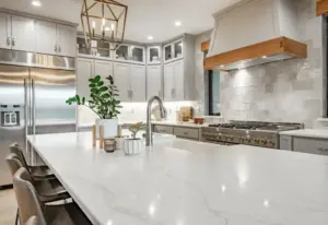 A white marble kitchen island with plants on top of it in a Springville, UT kitchen