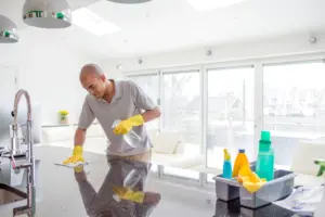 A man cleans superglue off of a countertop in his Springville, UT home