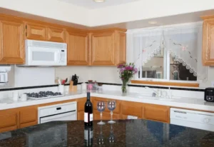 A black granite island and a white countertop in a Springville, UT kitchen