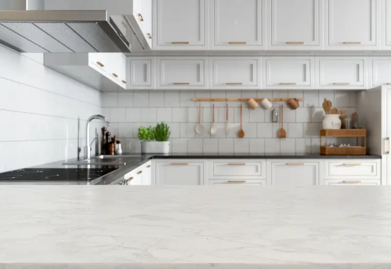 A closeup of a white marble countertop in a white kitchen in Springville, UT.