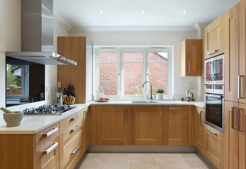  A white countertop compliments oak cabinets in a Springville, UT kitchen.